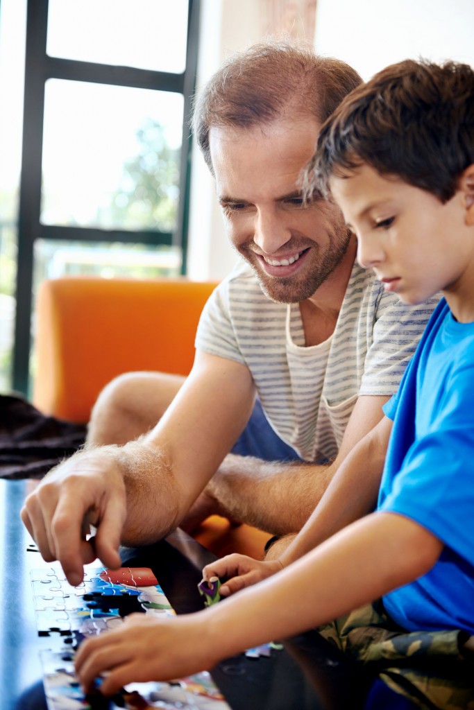 Psychologist testing young boy with shape activity.