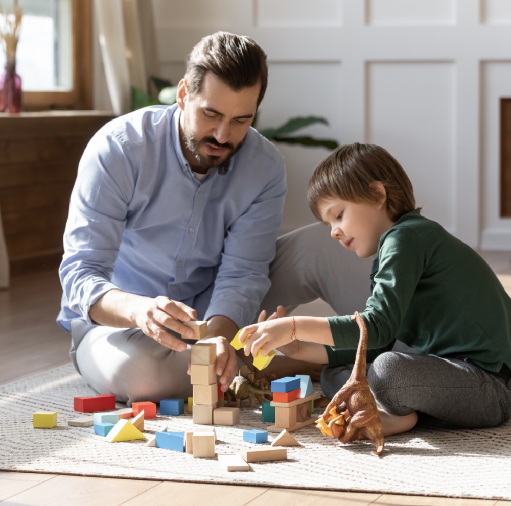 Psychologist talking and playing with shapes with young boy.