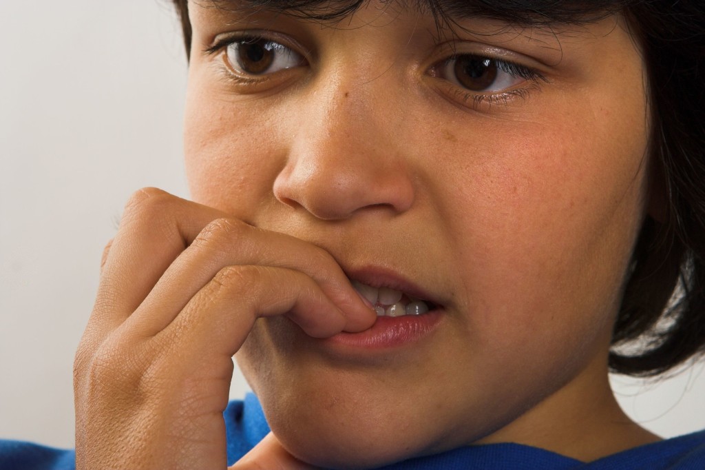 Child with Anxiety Disorder biting his nails.