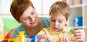 ABA Therapist using Comprehensive method to help child with shape activity