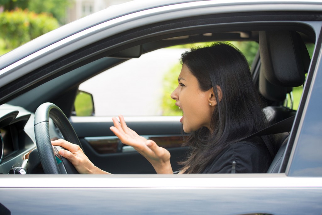 Angry stressful woman in car.