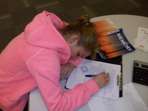 Teen falling asleep while studying. 