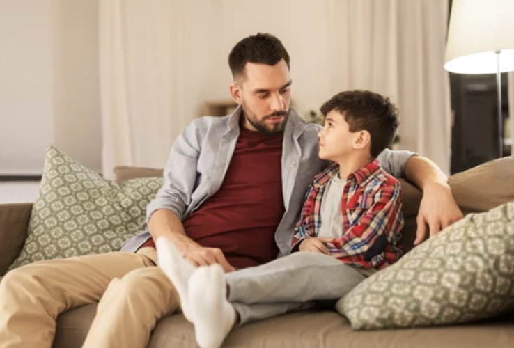 Father sitting down with son talking about good touch/bad touch