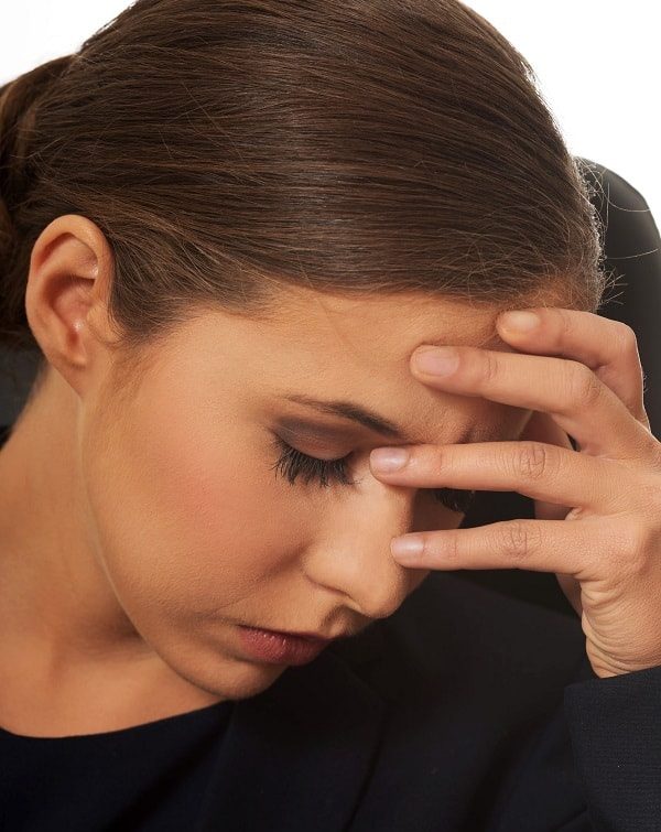 anxious woman holding her face.