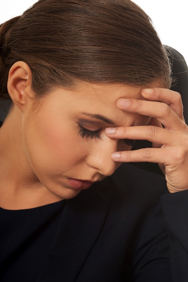 anxious/depressed woman holding her head