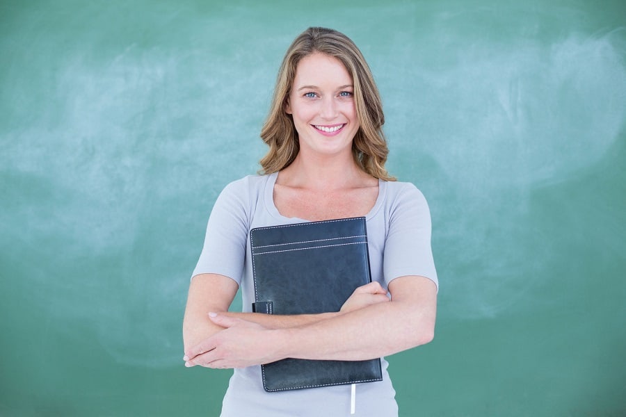 Psychologist smiling holding booklet.