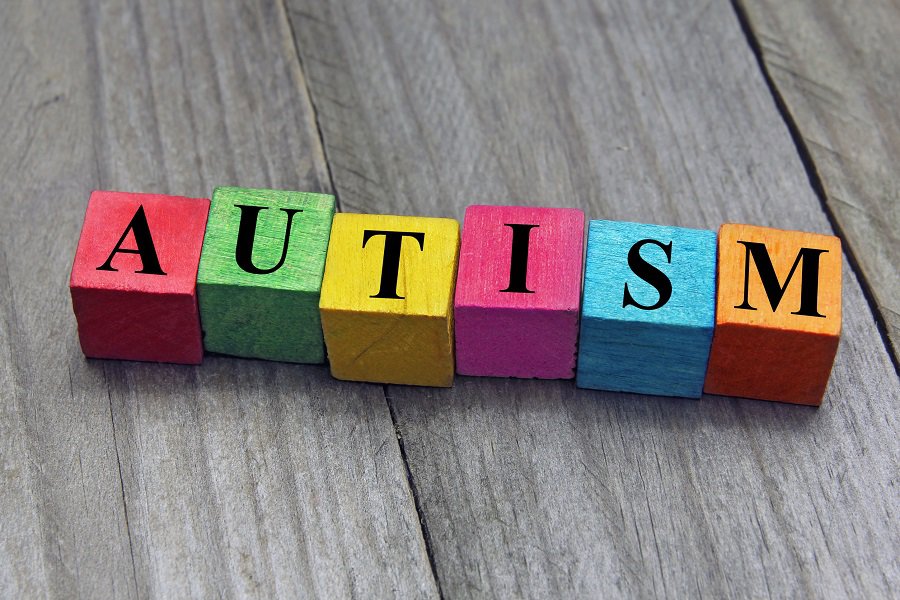 Color shape letter blocks spelling out AUTISM