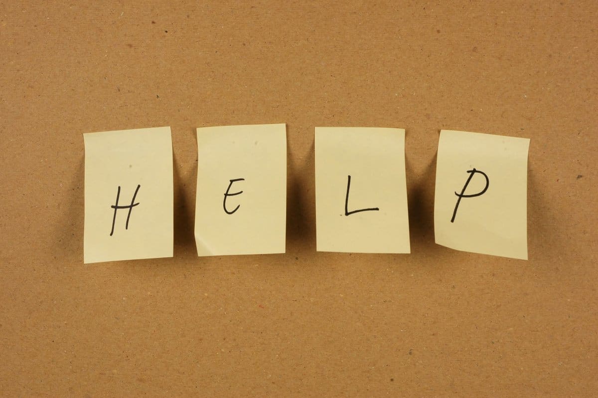 Post-it notes with the word "help" on bulletin Board