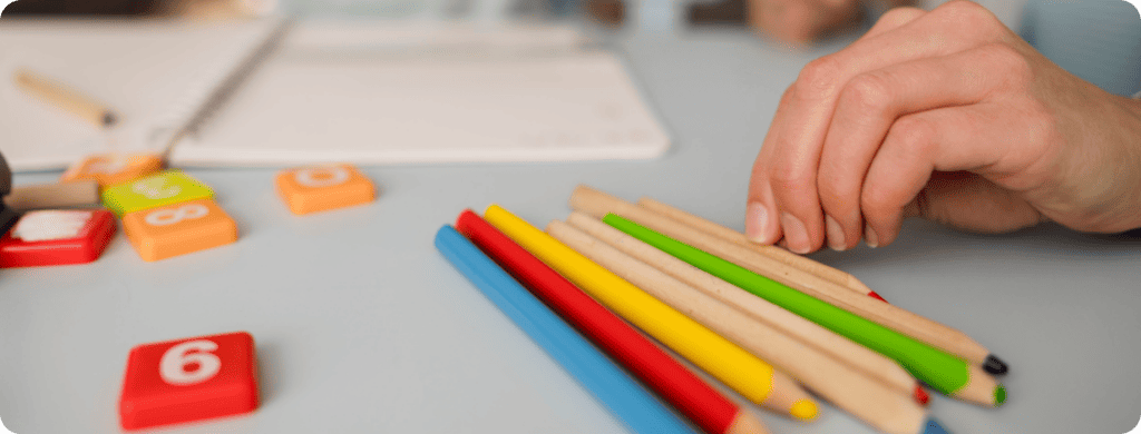 a close up of color pencils on table during tutoring session.