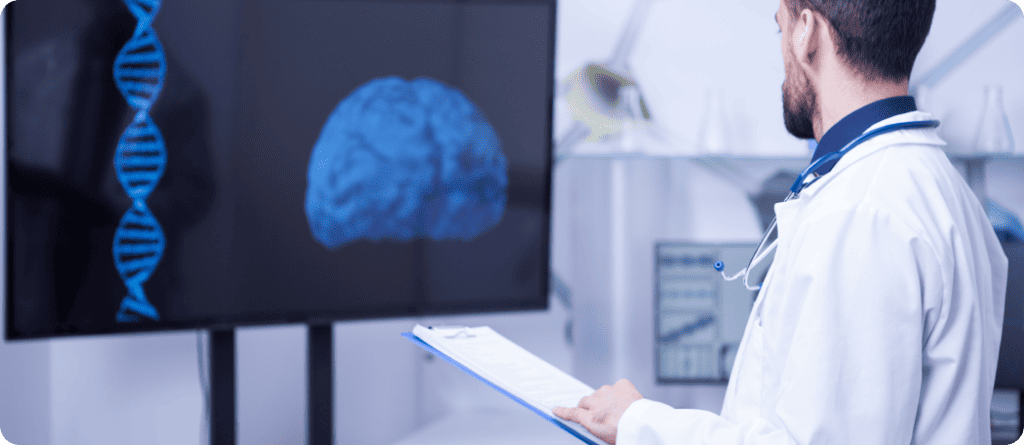 Doctor looking at brain on screen and trying to diagnosis while writing it down on clipboard.