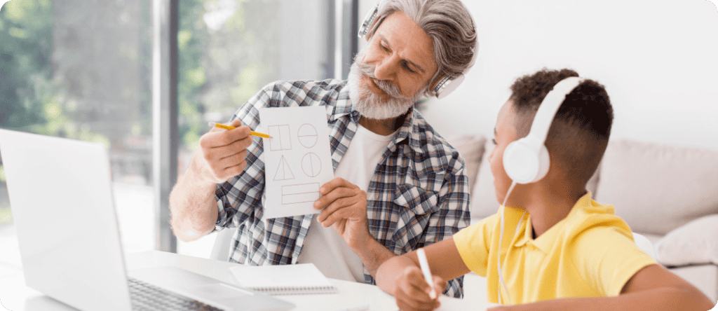 Psychologist showing young boy geometric shapes on piece of paper.