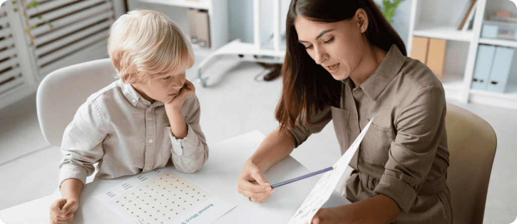 Pyschologist testing little boy with words and letters on piece of paper.