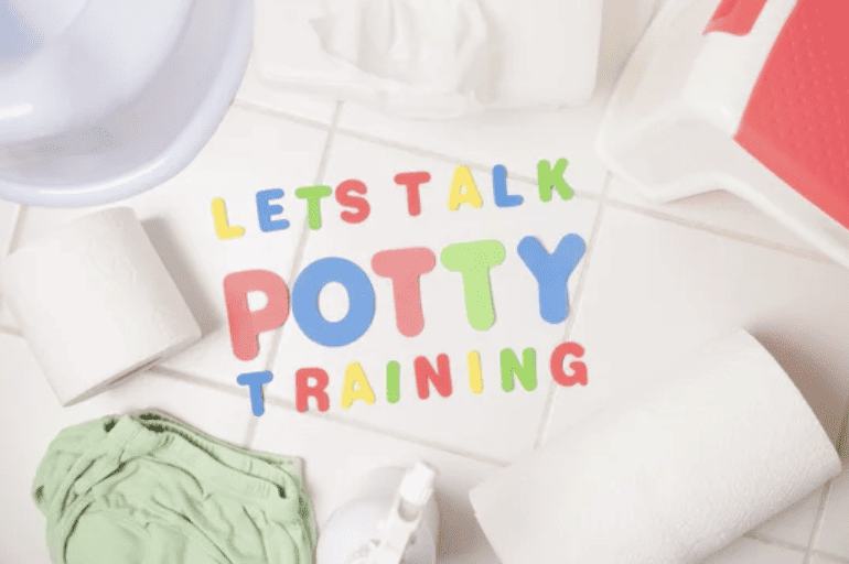 colorful letter spelling "Lets talk potty training" on bathroom floor