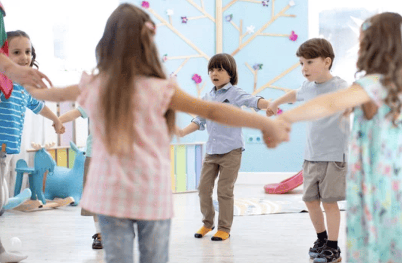 Group of kids holding hands while spinning playing game