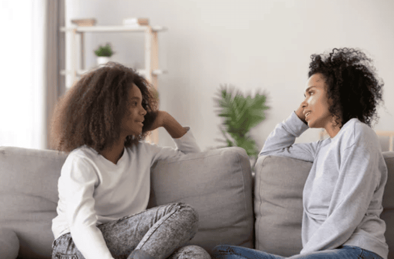 Teen and mother getting along on couch