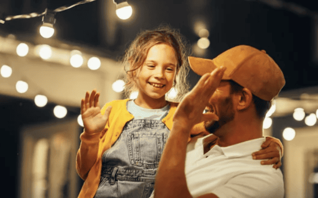 Father and daughter high five.