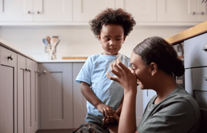 Young child comforting crying mother.