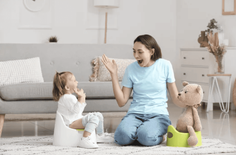 potty training pro helping toddler go potty. Both happy and smiling