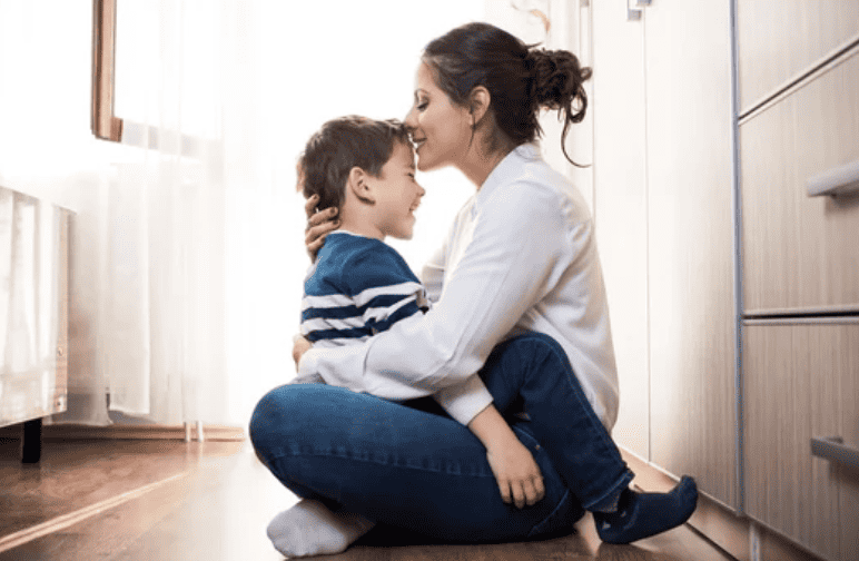 Mother having her little boy sit on lap.