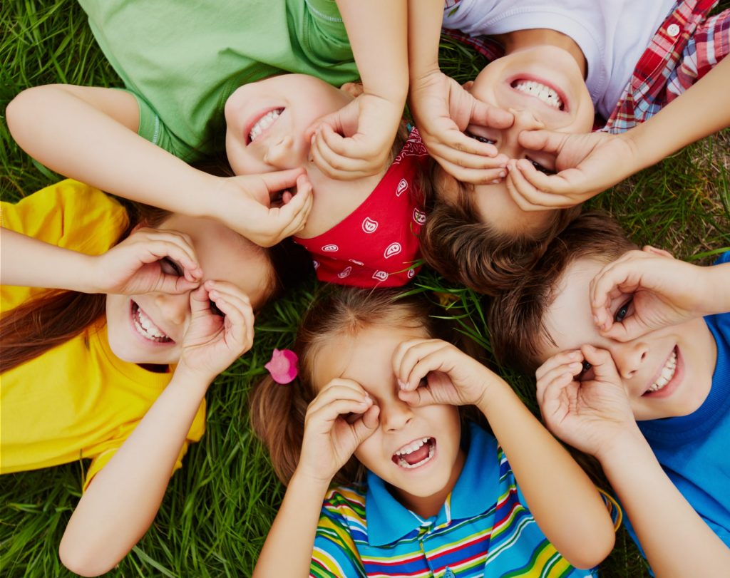 group of Kids on grass smiling