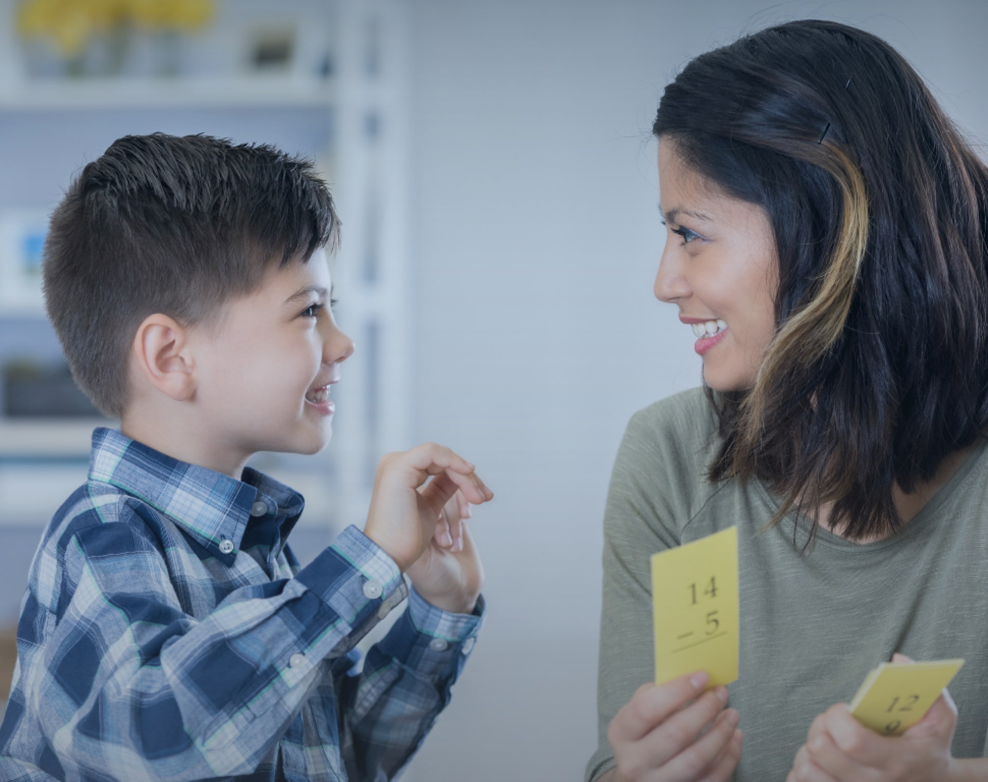 Psychologist and child smiling while doing group session activity