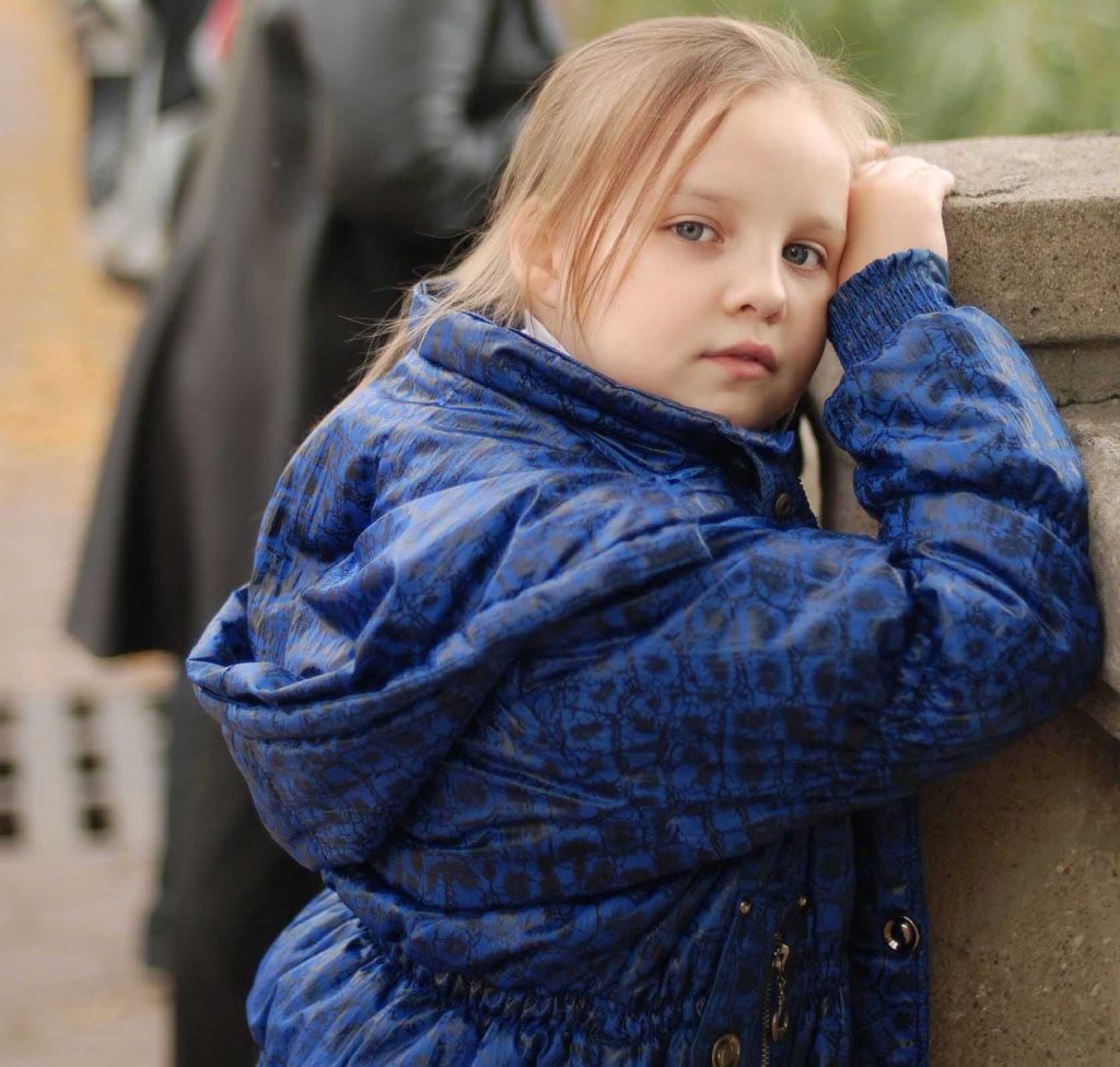 Child dealing with trauma abuse looking sad.